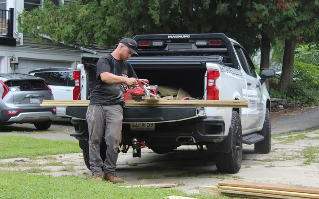 White Pine Builds contractor cutting lumber at a residential construction and remodeling job site.