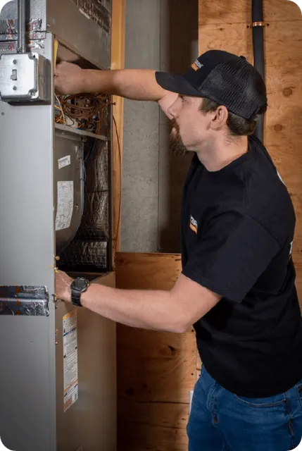 Precision Home Services technician performing HVAC maintenance as a Mitsubishi Diamond Contractor.