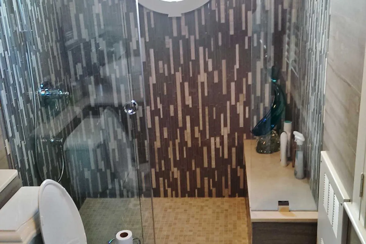 Dover House — contemporary bathroom with stacked stone mosaic shower surround.