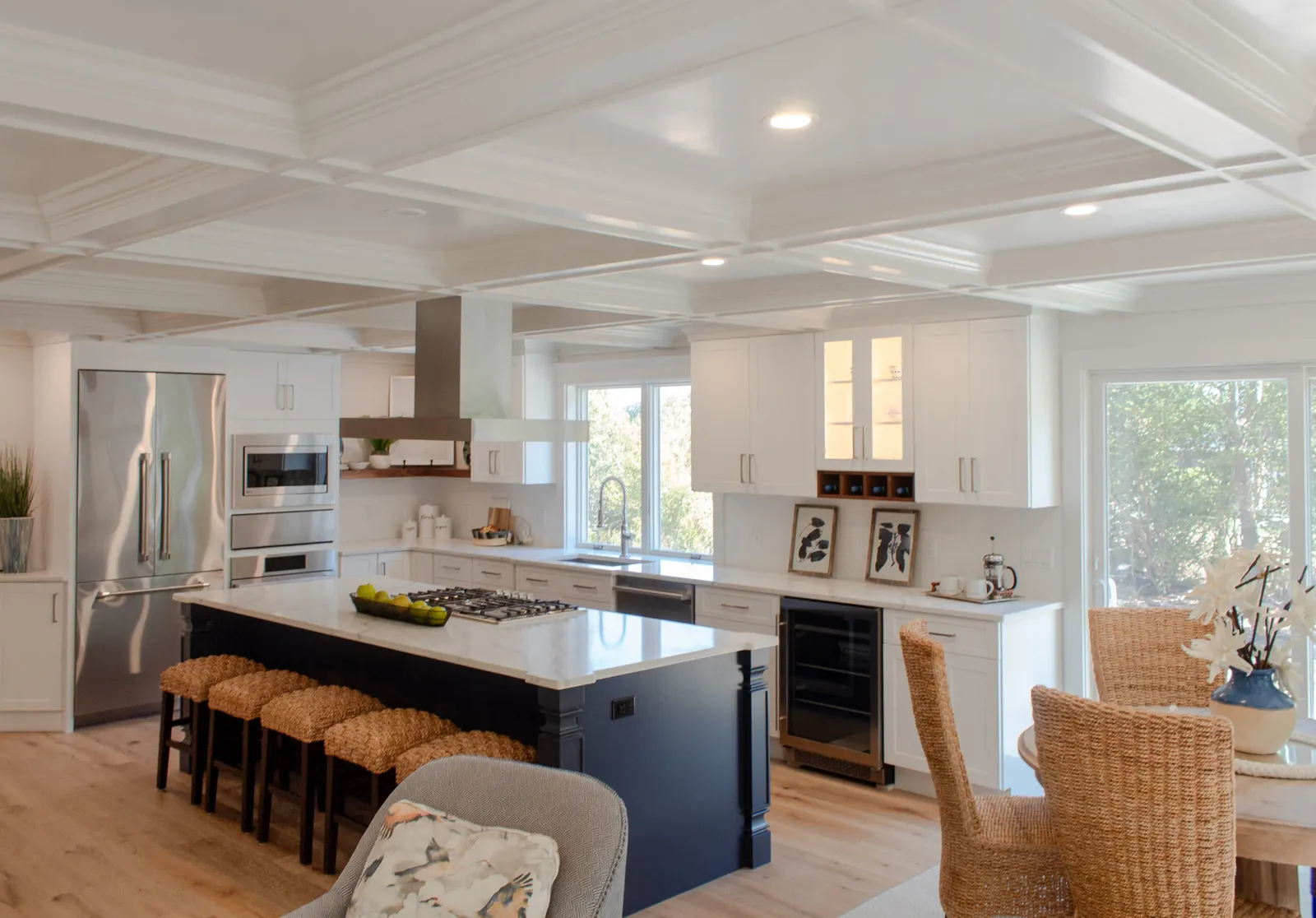 Coffered-ceiling kitchen with navy island and range hood