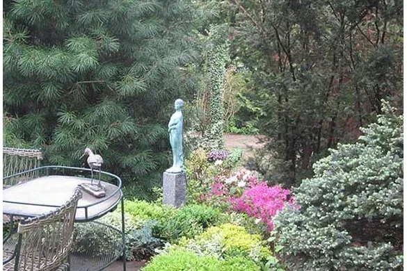 Terrace garden with statuary and layered evergreen plantings