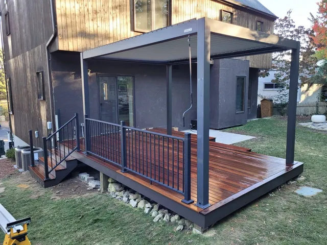 A beautiful hardwood deck with a versatile aluminum pergola installed on top of it for added function and beauty.