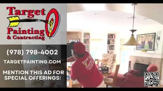 Target Painting crew member in a red company shirt painting an interior wall