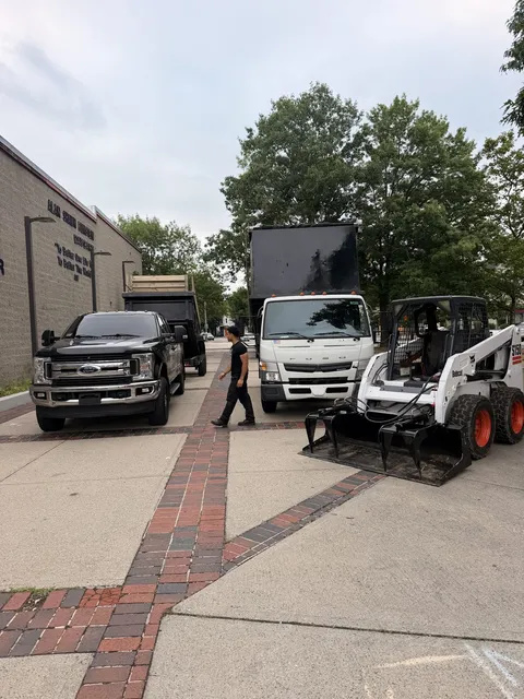 The company dump truck and skid steer staged and ready for a job