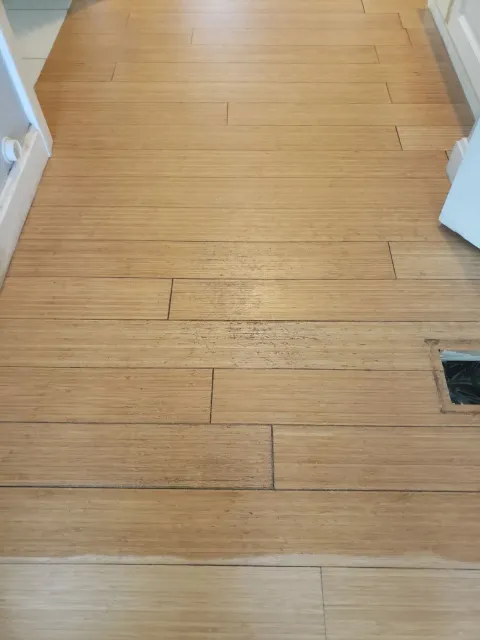 A wooden floor with a hole in the middle of it