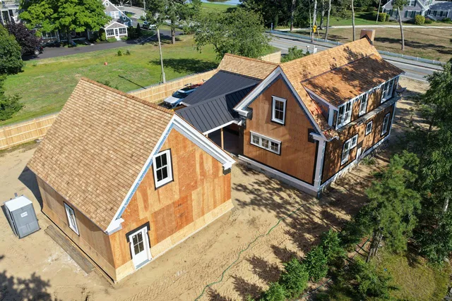 Dark standing seam metal porch roof with crisp white trim