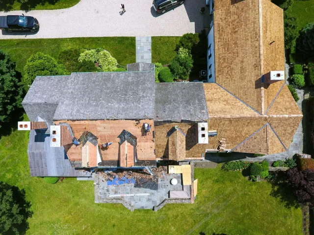 Aerial view of a cedar roof installation in progress