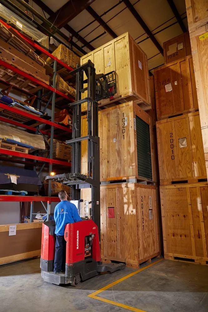 Warehouse storage vaults being handled by forklift