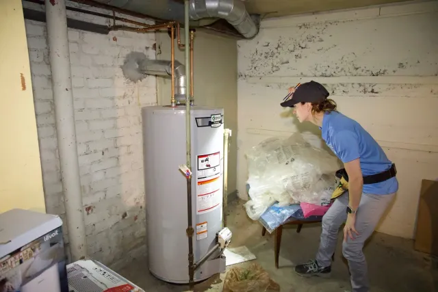 Trish at water heater.jpeg