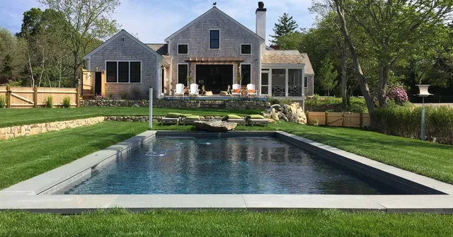 Pool set into ground with grass around it