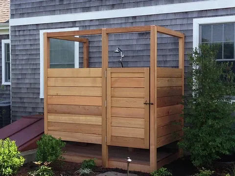 custom outdoor shower on the side of a house