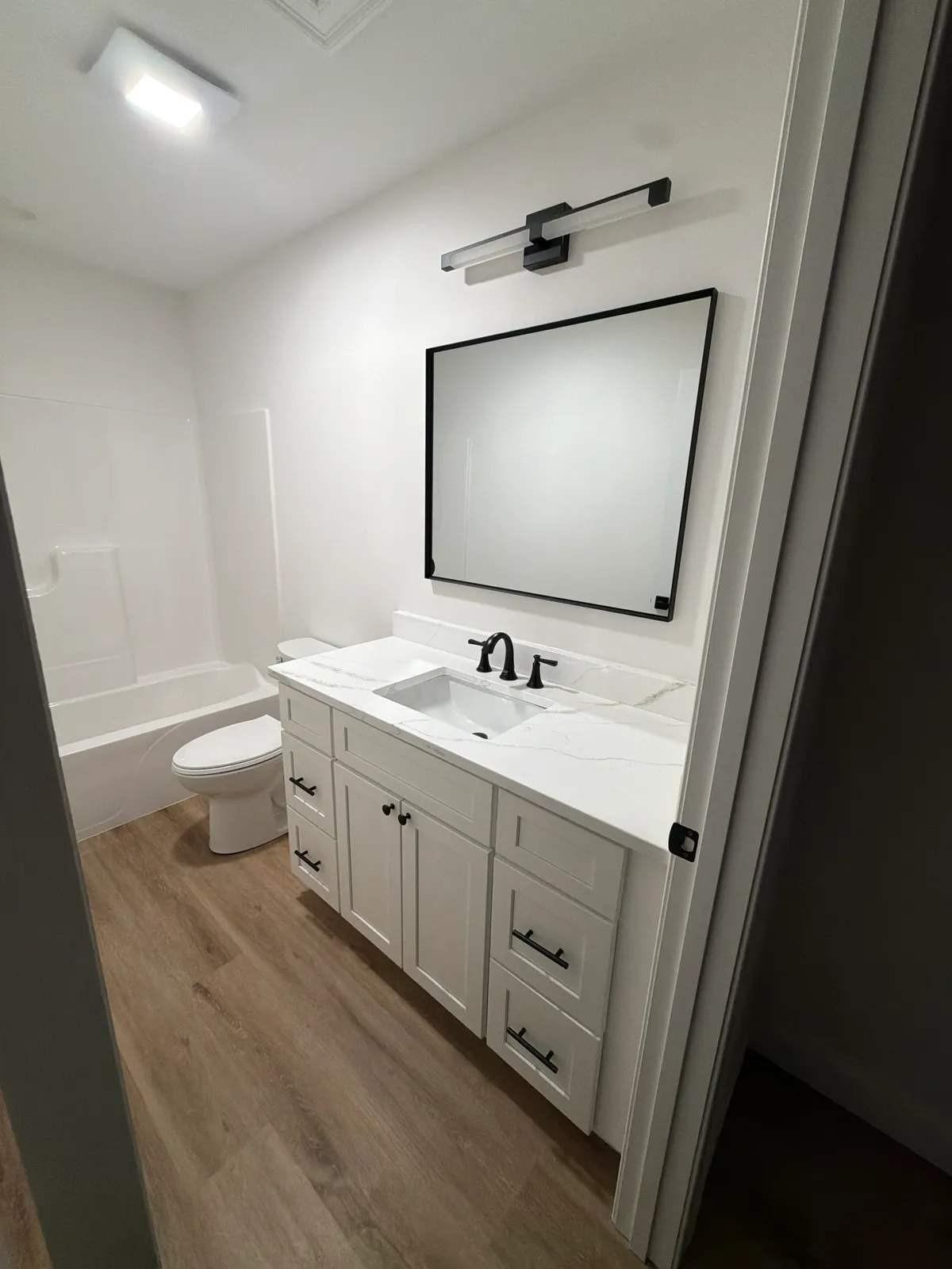 White bathroom vanity with quartz countertop installation