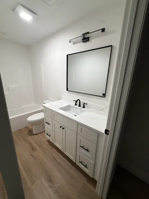White bathroom vanity with quartz countertop installation