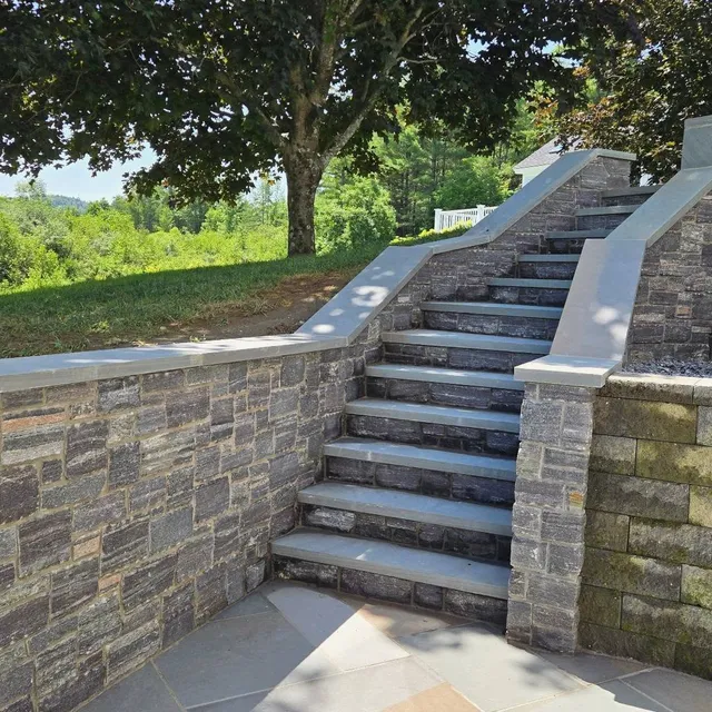 Corinthian granite veneer paired with full color bluestone. A basement entry that doesn't feel like one.