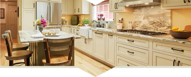 Beautifully remodeled kitchen with new cabinets, farmhouse sink, appliances, kitchen island, and granite countertops