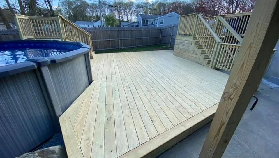 Custom pool and patio deck, pool entrance stairs and deck stairs connected to the house, made from natural wood
