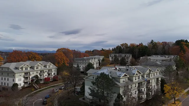 River Watch Condominiums Building 2 roof replacement Burlington VT with Green Mountains in background