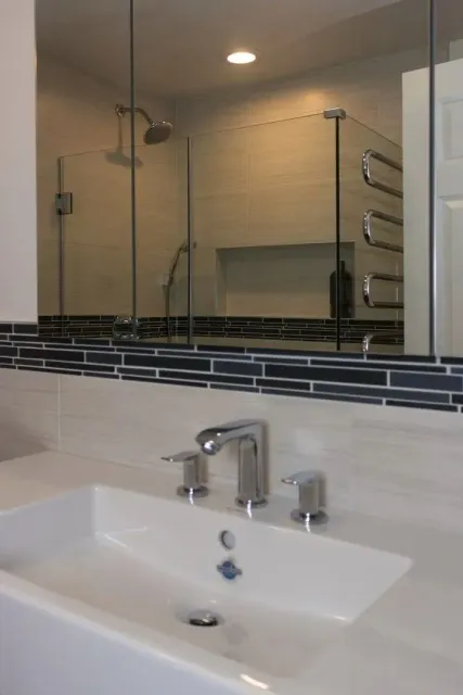 Bathroom vanity and tiled shower