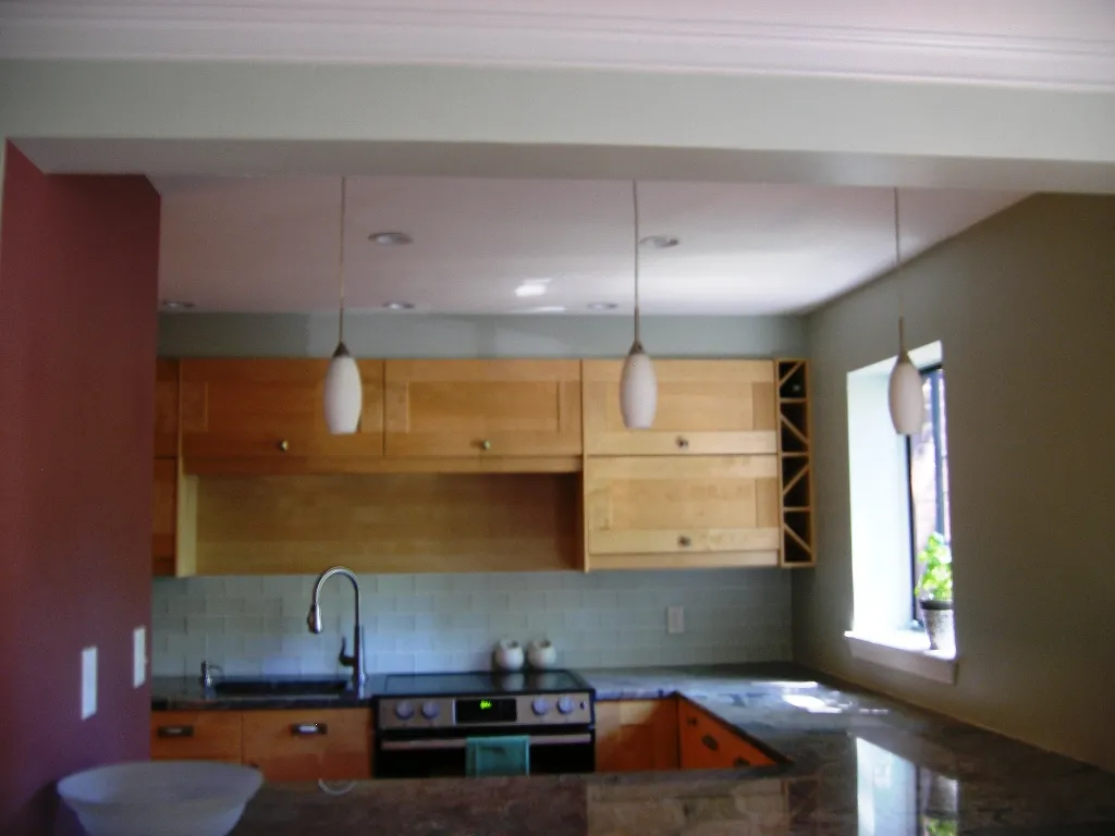 Basement kitchenette / wet bar with pendant lighting