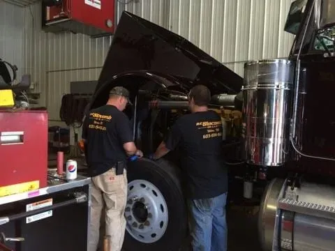 Dumspter Services — Men at work on Truck in Wilton, NH