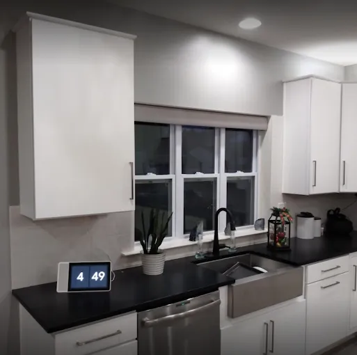 Modern kitchen refresh — smooth grey walls and ceiling with bright white cabinetry and trim. Interior painting.