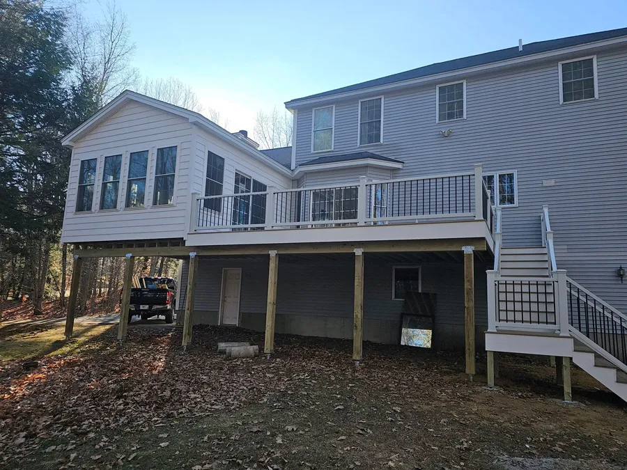 Addition with sunroom and full-width deck, completed