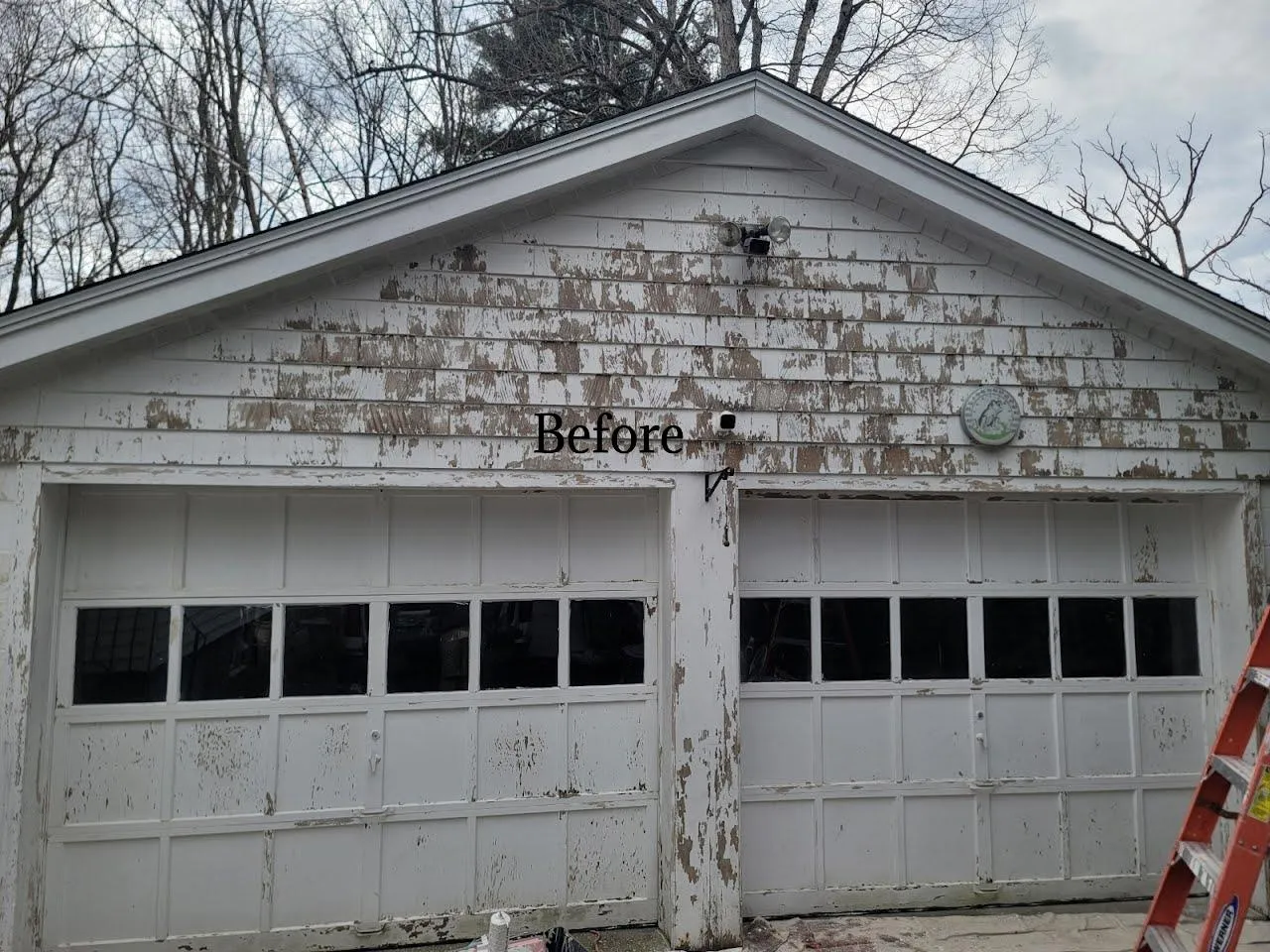 A garage in Worcester, MA, with peeling paint and a worn, decrepit appearance before being restored by Impeccable Painting.