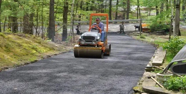 Man Driving Road Roller — Lunenburg, MA — Miller’s Paving, LLC