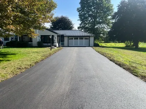 Newly paved driveway leading to a house