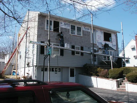 Second-storey addition being sheathed and wrapped