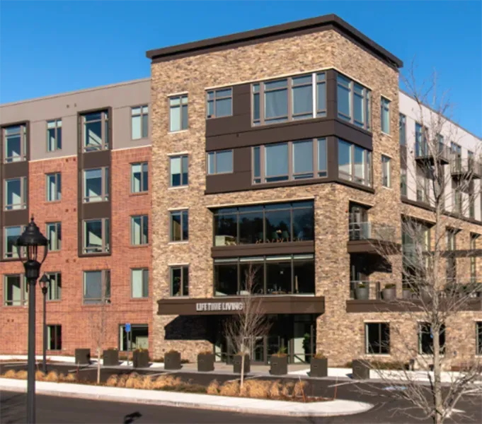 A large apartment building with a sign that says lifetime lounge.
