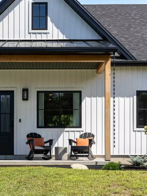 Front porch featuring two rocking chairs and a modern farmhouse design.