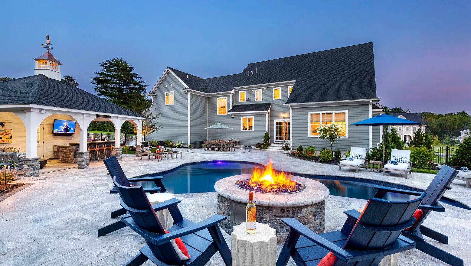 Backyard fire pit overlooking pool and home