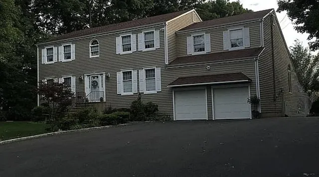 Colonial home with two car garage after renovation and addition