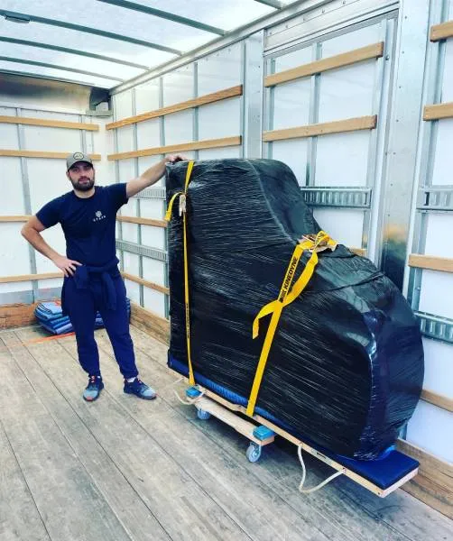 mover leaning against a pino