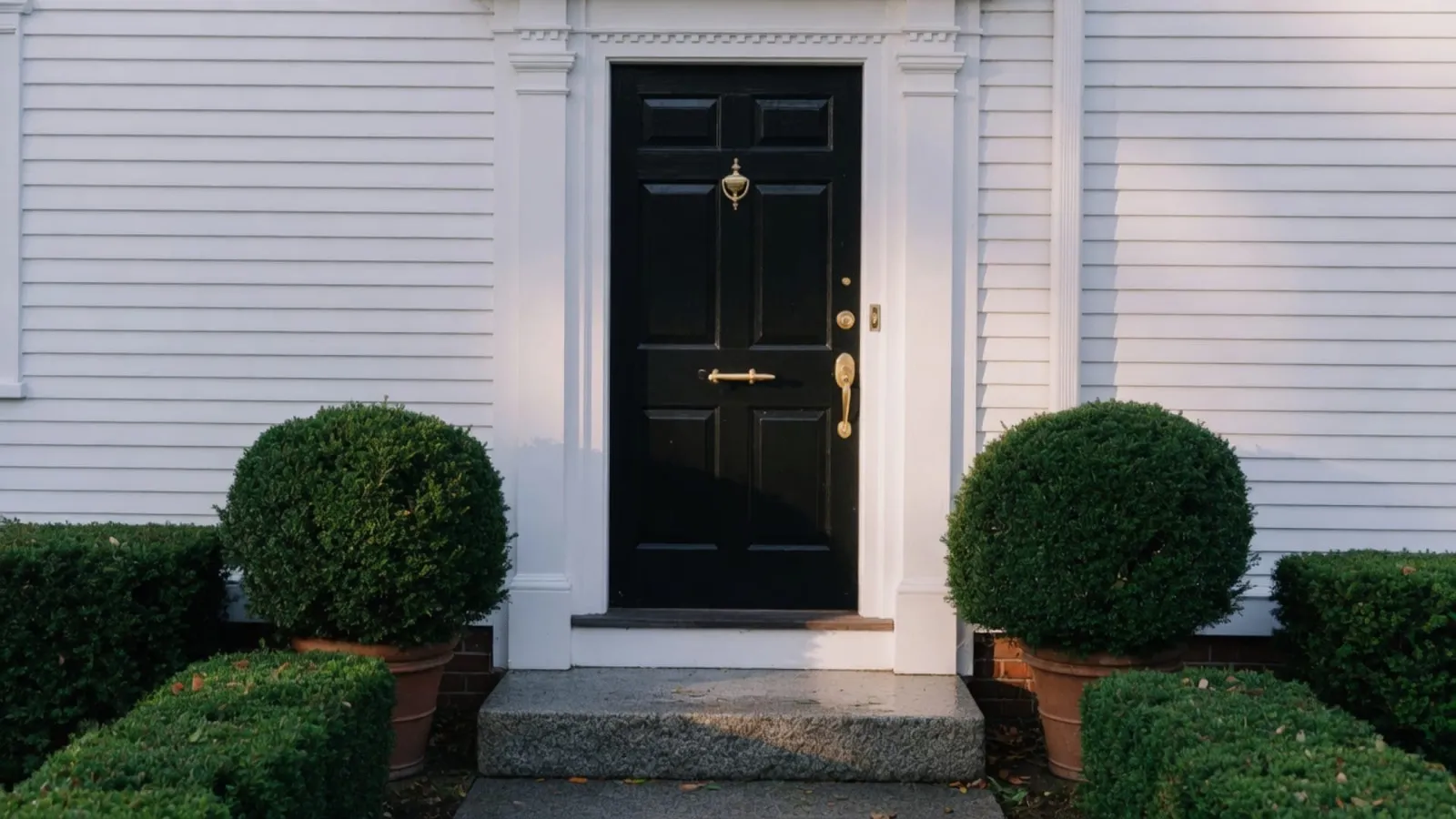 Black painted colonial front door with brass hardware, Wellesley MA, morning light, no people