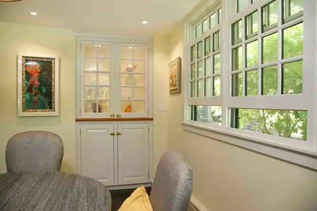 Kitchen dining area with build in hutch and open windows