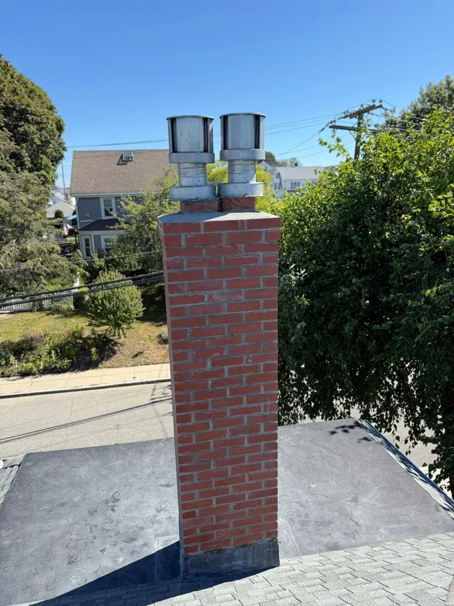 Tall chimney dual caps tuckpointed — Chimney Goat project