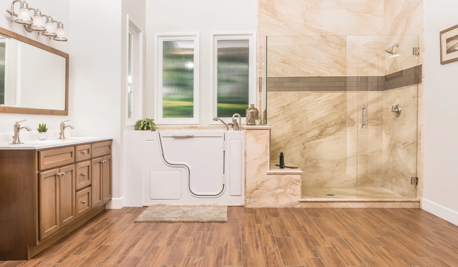 Re-Bath's French Mocha Transitional bathroom design featuring French Mocha DuraBath Natural Stone wall surround, Santa Fe walk-in tub in smooth white with brushed nickel hardware, and Bertch cabinet with brushed nickel knobs.