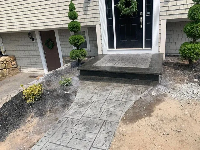 Front door with concrete walkway.