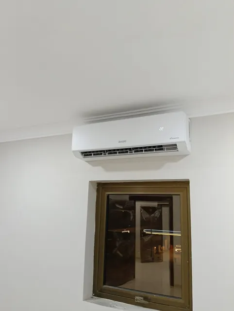 Mini-split indoor head mounted above a window