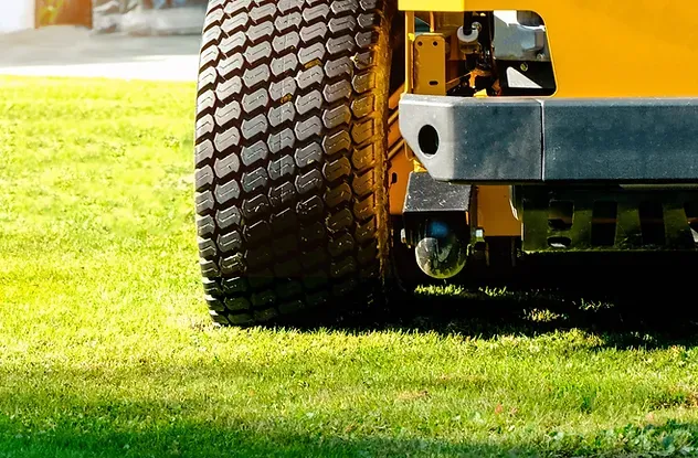 The yellow zero-turn mower parked in the