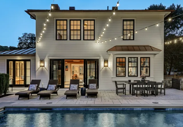 Exterior painting project at dusk with pool and patio