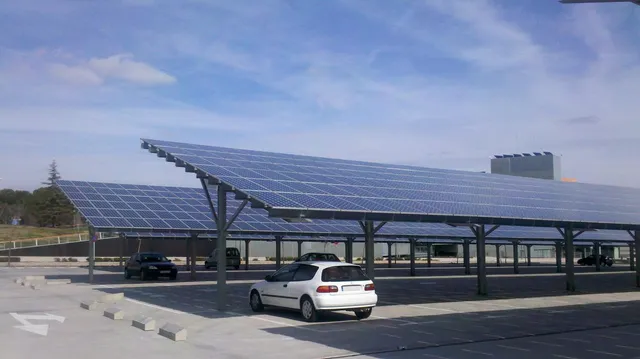 Rows of solar carports shading vehicles in a commercial parking lot.