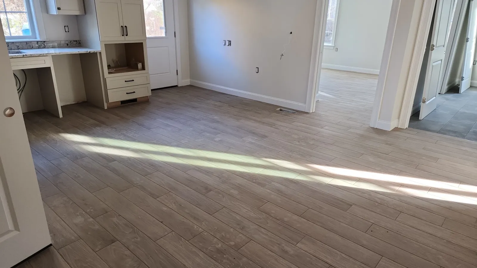 Finished plank-format tile floor in a sunlit living space