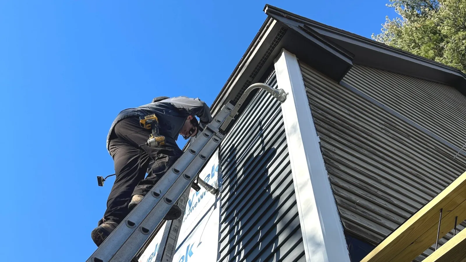 Oranssi technician working on a roof project