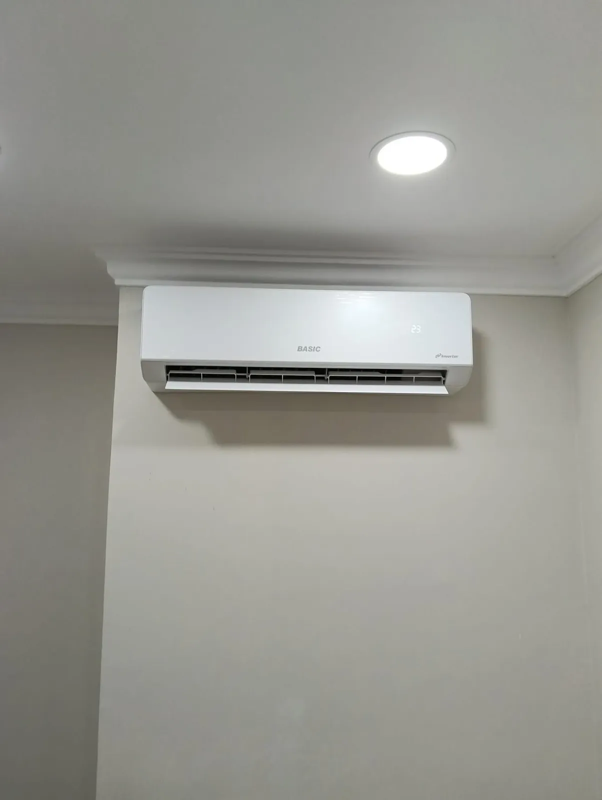 Wall-mounted mini-split indoor head installed in a finished room