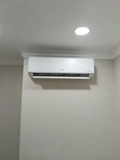 Wall-mounted mini-split indoor head installed in a finished room