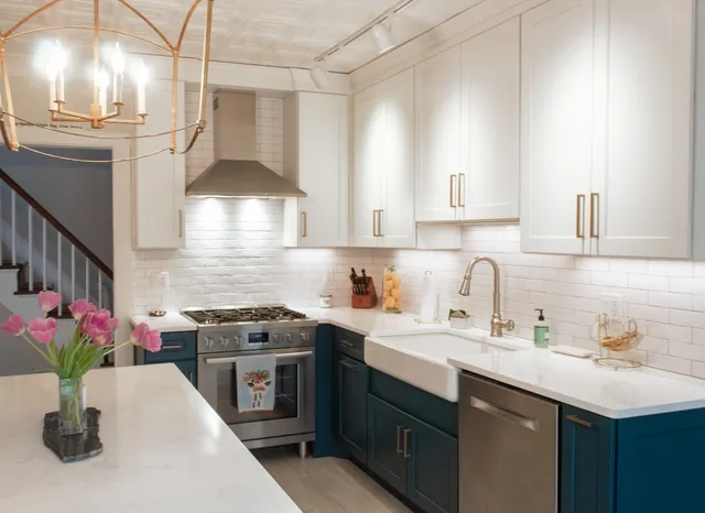 Navy base cabinets with brass hardware and marble counters