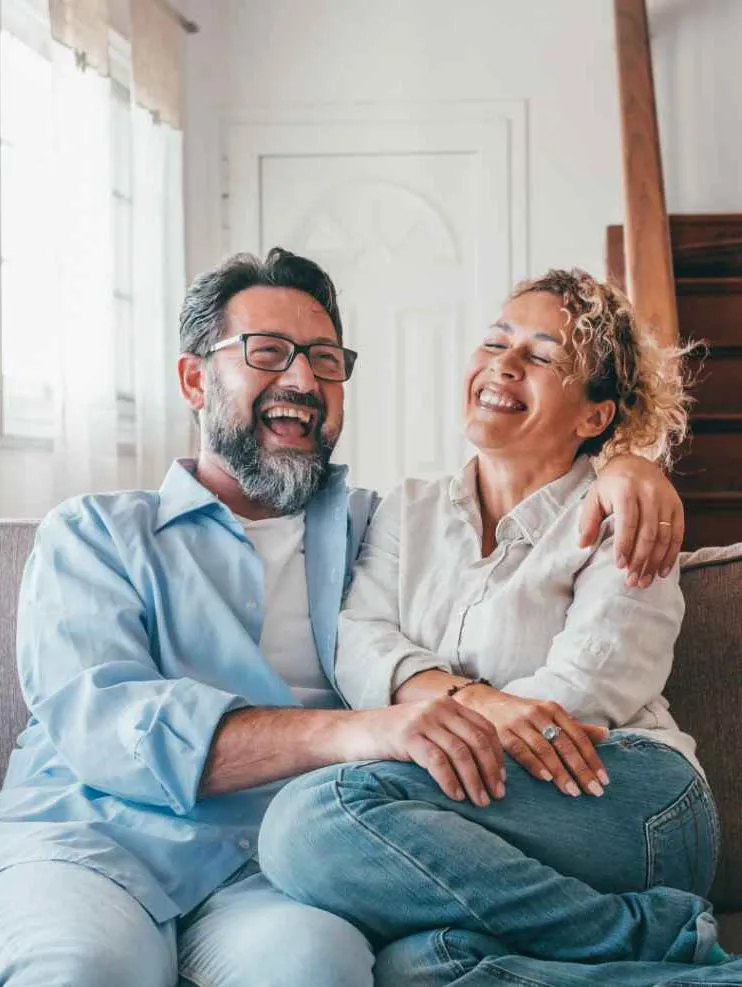 Couple laughing on couch